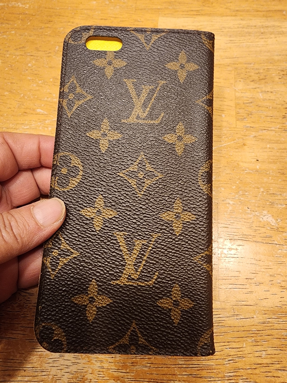 Louis Vuitton Monogram iPhone Folio Case crafted in the brand's signature brown